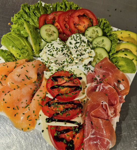 Frühstücksplatte mit Lachs, Schinken, Käse und frischem Gemüse